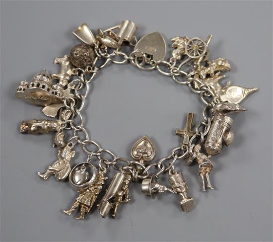 A white metal charm bracelet hung with assorted charms including Brighton Pavilion.